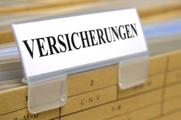istock binder printed with insurance - in German language: Versicherung 976575334