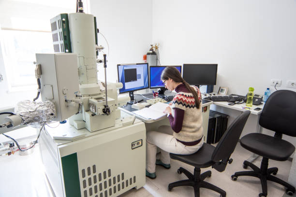 istock Female Scientist Looking at Research Results From Field Emission Electron Microscope 976578644