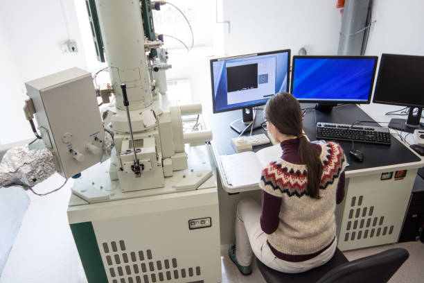istock Woman Scientist Doing Research in Field Emission Electron Microscope Laboratory 976578646
