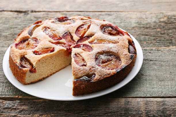 istock Sweet plum cake on grey wooden table 976578696