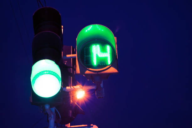 istock Green traffic light with colorful unfocused lights on a background 976579032