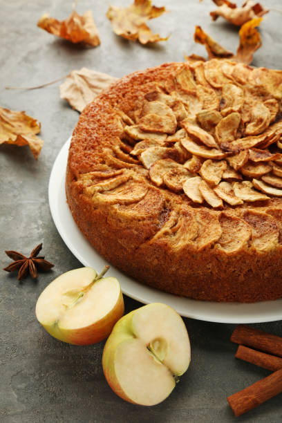 istock Apple cake with cinnamon and star anise on grey wooden table 976581632