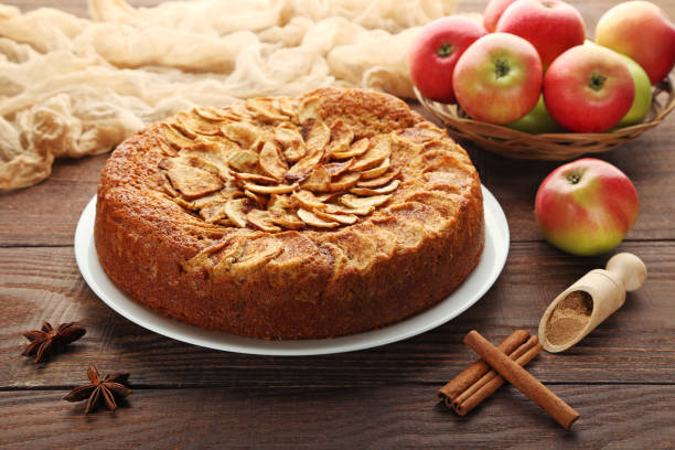 istock Apple cake in plate on brown wooden table 976581880