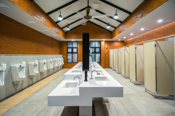 empty public restroom have clean, comfortable interiors with white porcelain urinals. interior of the male toilet with washstands mirror, male restroom. - urinal clean contemporary in a row imagens e fotografias de stock