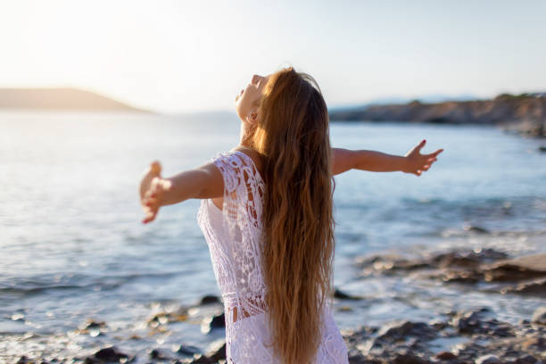 istock Woman in happiness on the beach 976585214