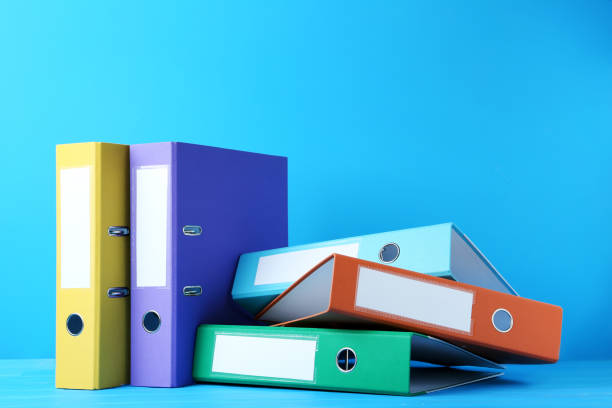 istock Colorful office folders on blue background 976591576