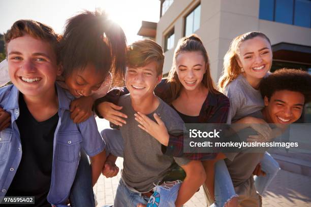 Foto de Retrato De Estudantes Do Ensino Médio Dando Uns Aos Outros Edifícios Do Colégio Sobreposto e mais fotos de stock de Adolescente