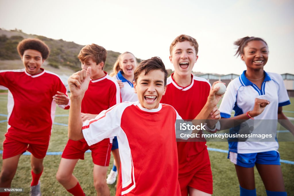 Portrait Of Male And Female High School Soccer Teams Celebrating Child Stock Photo