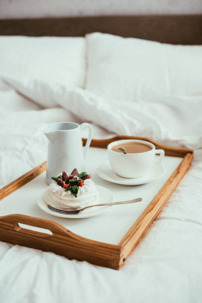 istock Cozy home breakfast in bed in white bedroom interior 976598514
