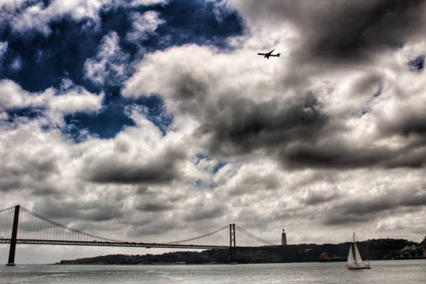 istock 25th April Bridge in Lisbon on a cloudy day 976604388
