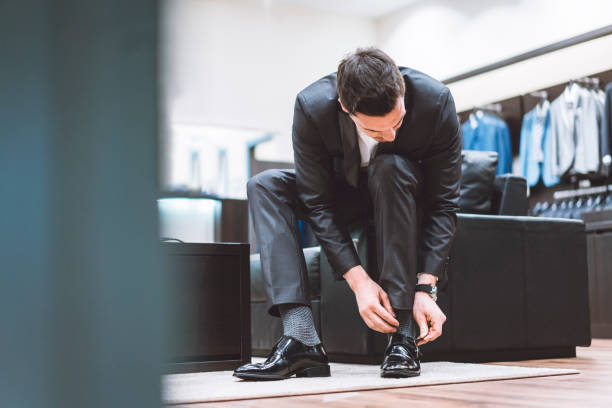 istock Man trying on classic leather shoes 976604406