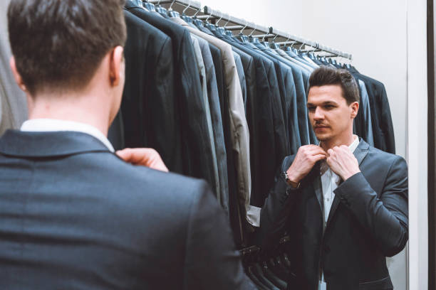 istock Handsome businessman trying on a suit 976610990