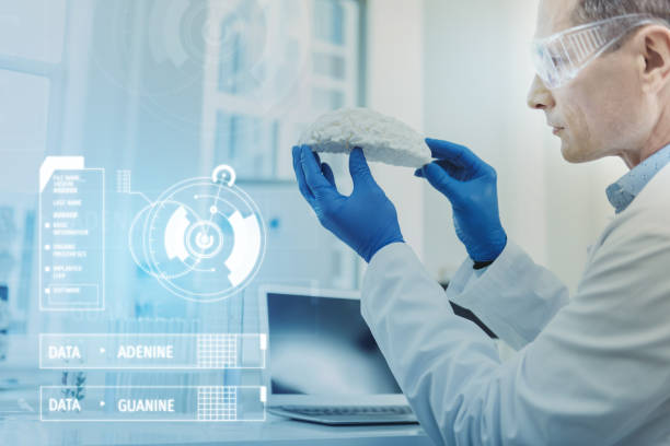 istock Serious man frowning while working with the brain model 976616046