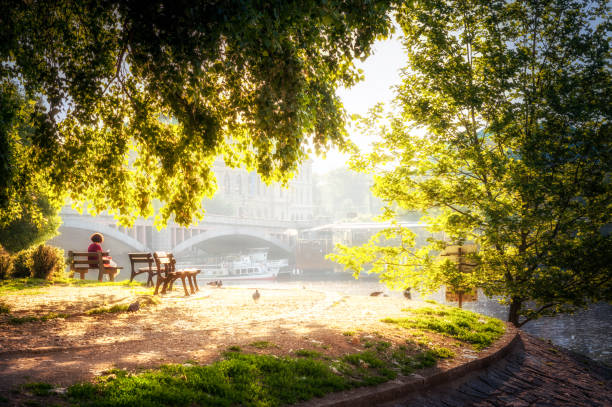 27 may 2018: woman resting in a bench in front of vltava river in Prague. Czech Republic