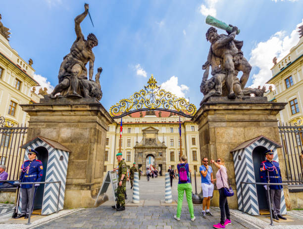 tourists in Prague castle main entrance. Czech Republic 26 may 2018: tourists in front of the Giants Gate (aka Wrestling Giants) in Prague Castle. Prague, Czech Republic hradcany castle stock pictures, royalty-free photos & images