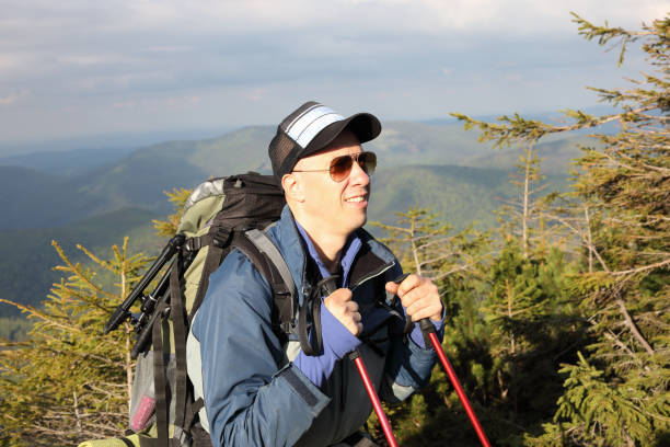 istock Active healthy man hiking in beautiful forest 976619442