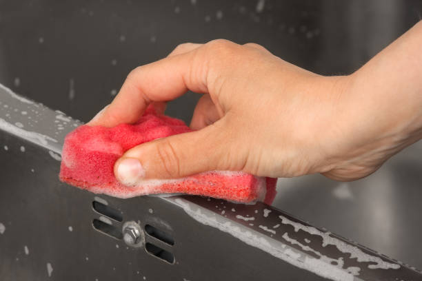 istock hand cleaning kitchen sink, closeup 976620350