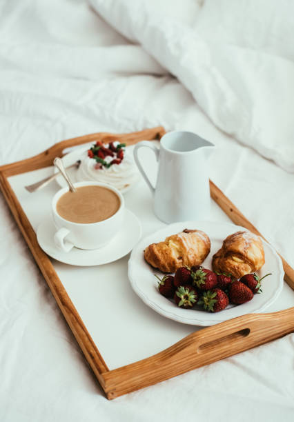 istock Cozy home breakfast in bed in white bedroom interior 976620820