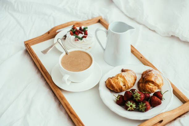 istock Cozy home breakfast in bed in white bedroom interior 976620954