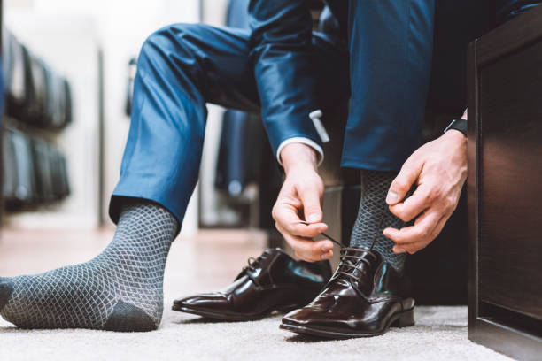 istock Businessman trying on elegant shoes 976620978