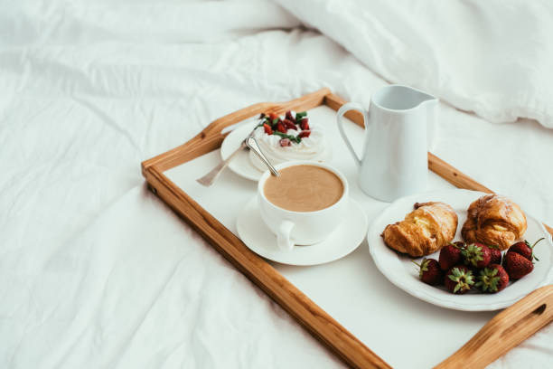 istock Cozy home breakfast in bed in white bedroom interior 976621018