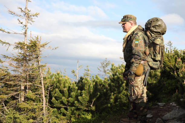 istock Active healthy man hiking in beautiful forest 976623918