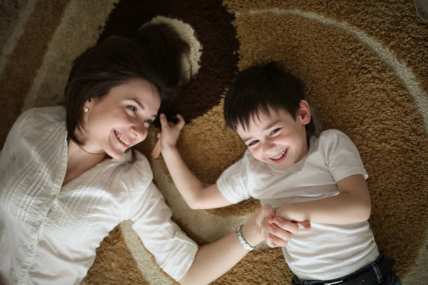 istock Beautiful brunette mom playing and hugging with son 976630048