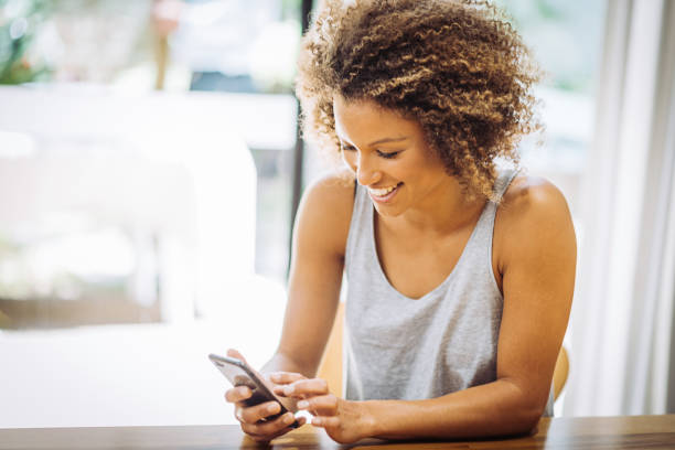 istock Mixed race woman using phone 976630212