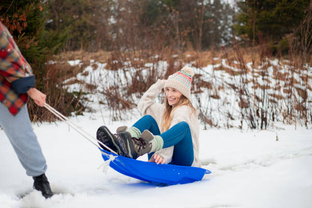 istock Young Woman on a Sled 976630546