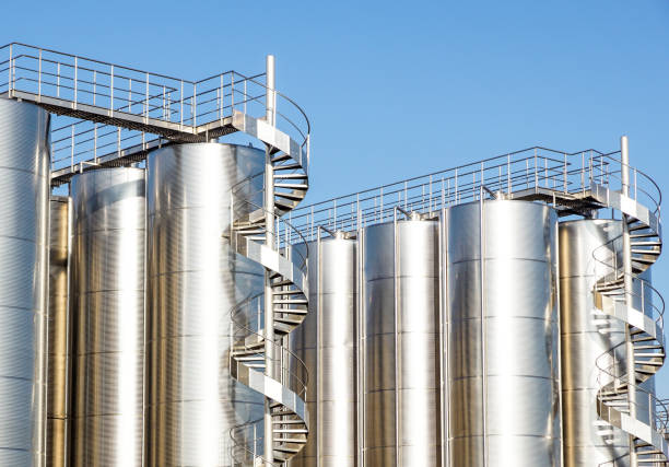 istock Silver wine Silos with blue sky in background 976630568