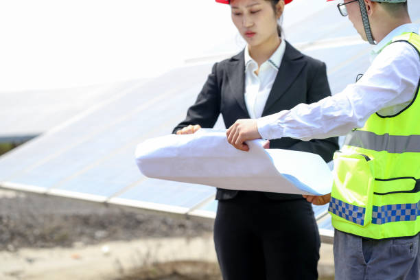 istock Engineer and businesswoman discuss construction plan at electrical equipment base 976633446