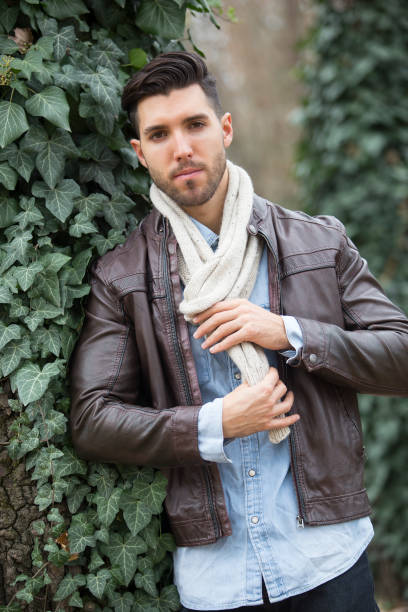 istock young sexy man posing in forest.autumn day 976637988
