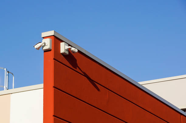 istock video camera security system on the wall of the building 976640978