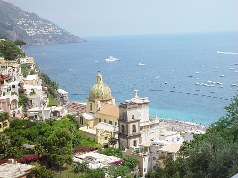 Positano is a famous resort with a pebble beach and steep narrow streets lined with boutiques and cafes. The local church of Santa Maria Assunta is famous for its majolica-faced dome and the 13th century Byzantine icon of the Virgin Mary. The Walking Trail of the Gods connects Positano with other coastal towns.