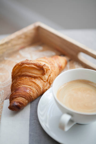 istock Croissant and coffee on a tray 976652368