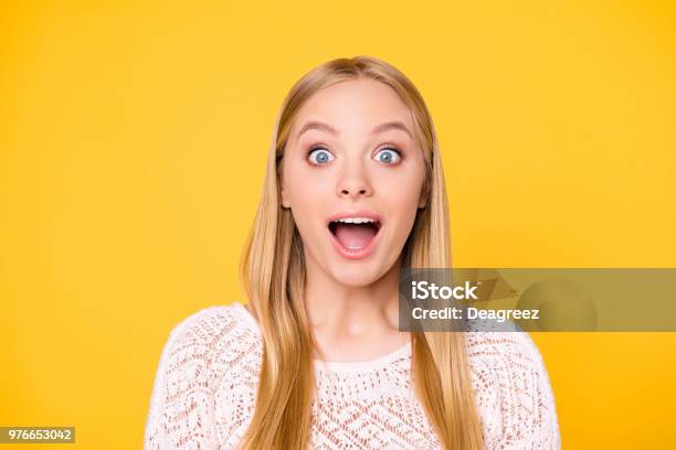 Head Shot Portrait Of Astonished Surprised Girl With Wide Open Mouth Eyes Looking At Camera Isolated On Vivid Bright Yellow Background Stock Photo - Download Image Now