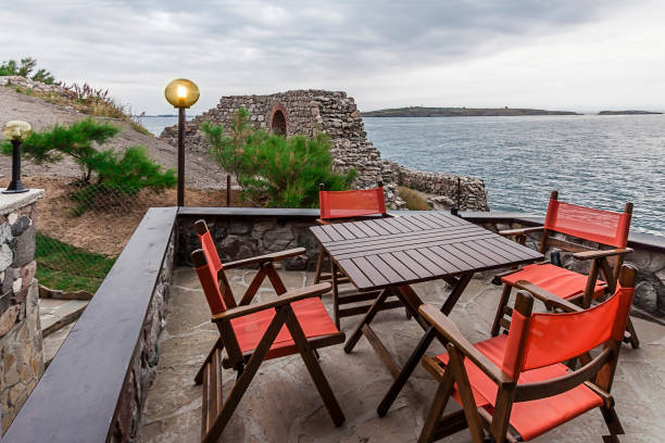 istock Sea coastline cafe tables summer sunny day. 976657080