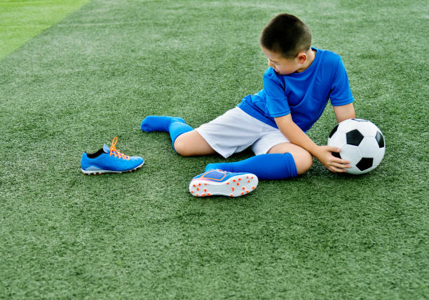 istock Young football player falling down 976657376