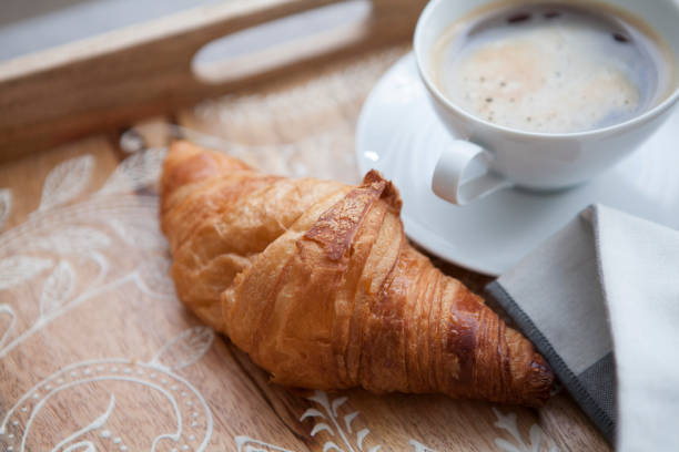 istock Croissant and coffee on a tray 976660258
