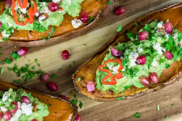 Photo of Baked sweet potatoes with guacamole, feta cheese and pomegranate