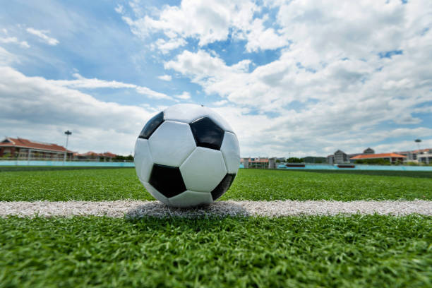 istock Soccer ball on white line 976660474
