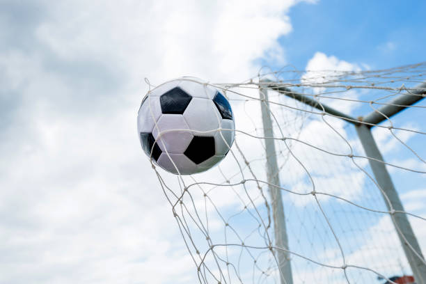 istock Soccer ball hitting the net 976661786