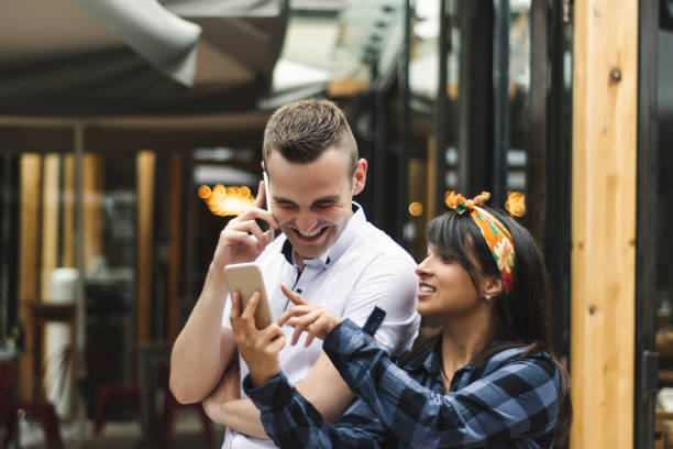 istock Young people talking on a phone 976671118
