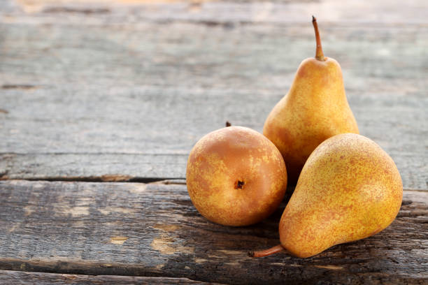 istock Ripe and sweet pears on grey wooden table 976676794