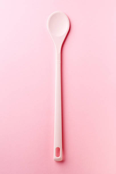 istock Pink silicone spoon on pink, from above 976679668