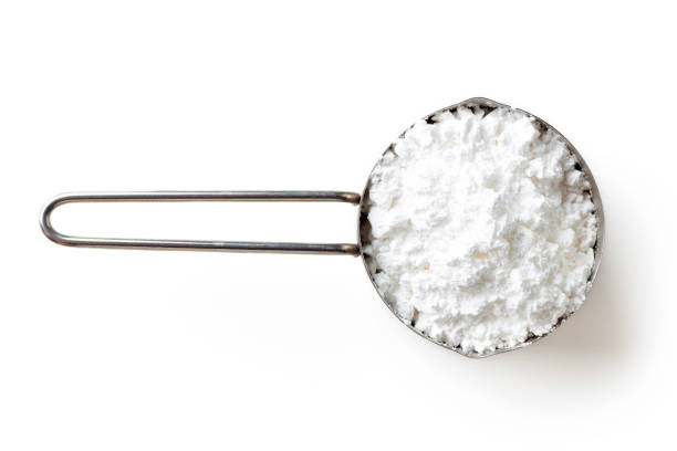 istock Measuring scoop with powder sugar isolated on white background, top view 976679824