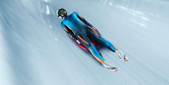 Male Luger glides on the sleigh in professional Luge Track on competition. Sportsman dressed in a suit for sledge sports and protective helmet