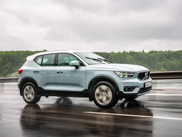 Volvo XC40 Minsk, Belarus - June 15, 2018: Volvo XC40 drives on a highway during rainy summer day. Volvo XC40 is the first subcompact SUV made by Volvo. Under the bonnet of this T5 AWD model is a 2.0-litre turbo-petrol engine with a substantial 250bhp. volvo stock pictures, royalty-free photos & images