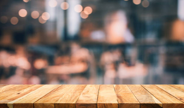 istock Wood table top with light gold cafe,restaurant background 976736436