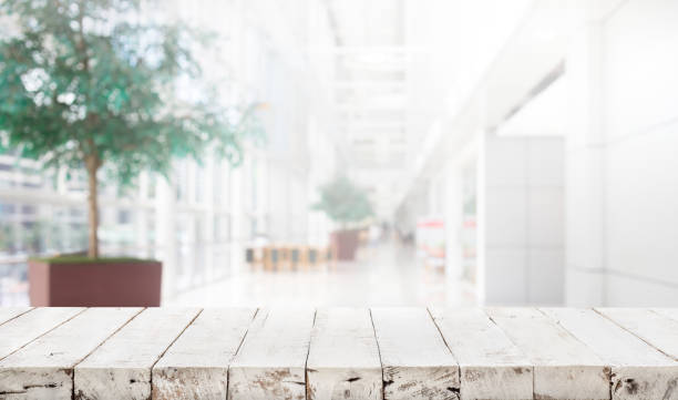Wood table top on blur building hall background